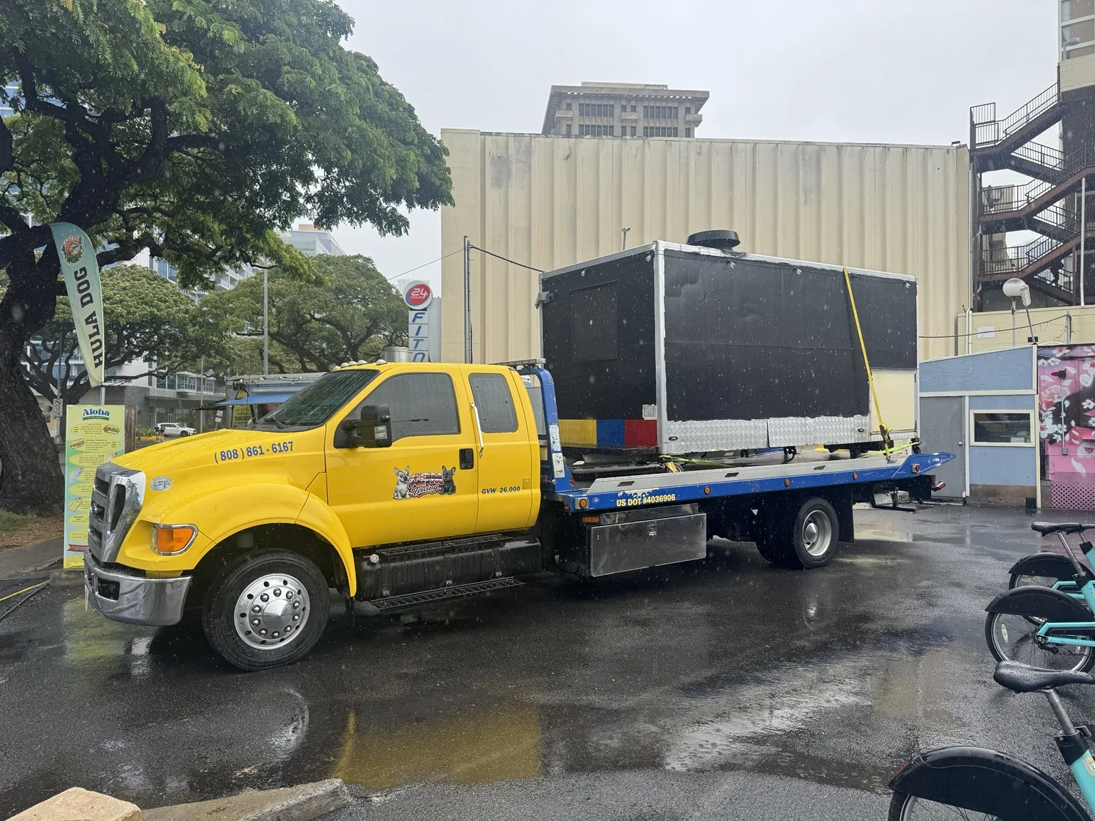 APM Towing flatbed transporting large equipment in Honolulu