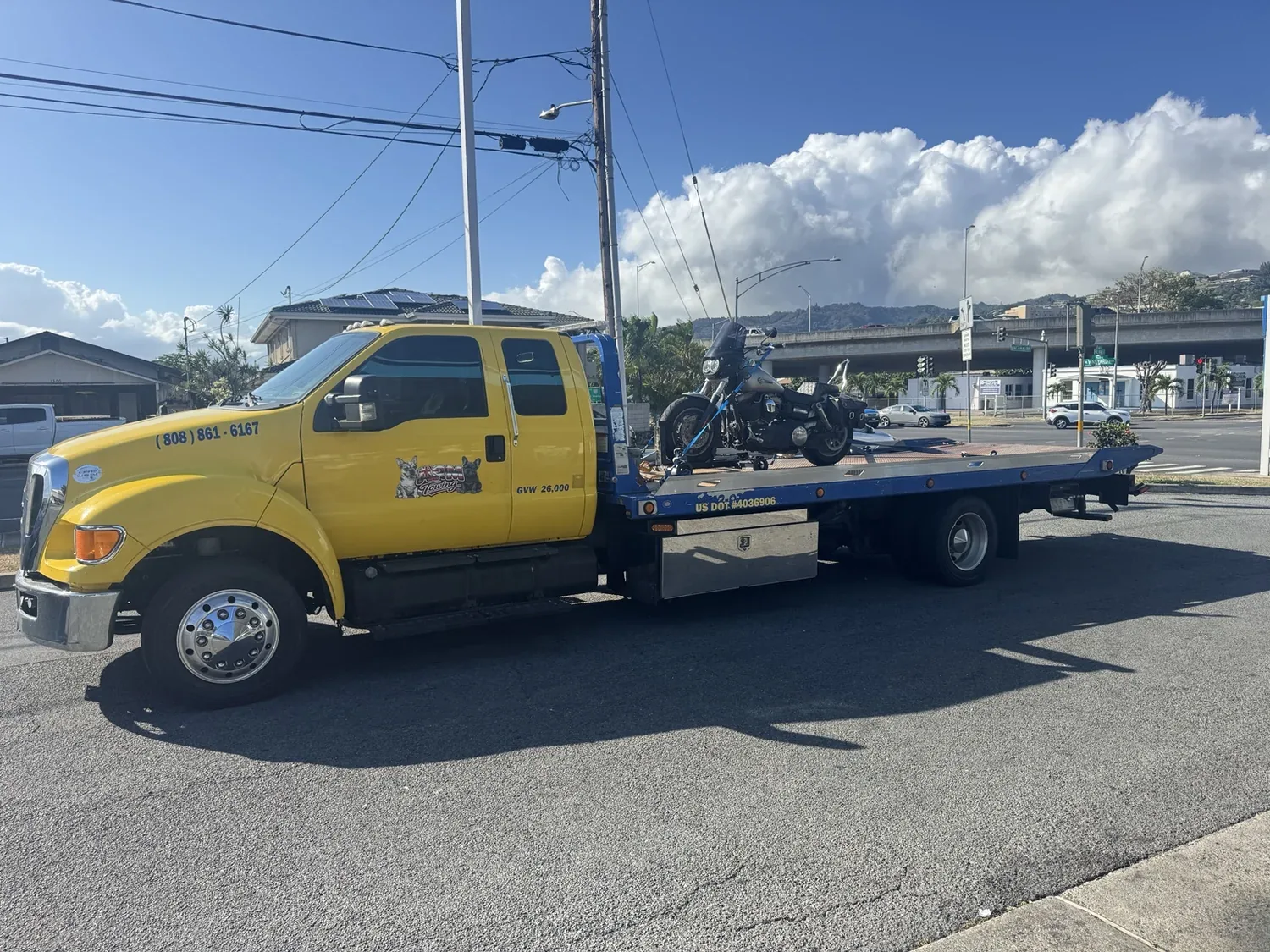 Motorcycle secured on an APM Towing flatbed truck