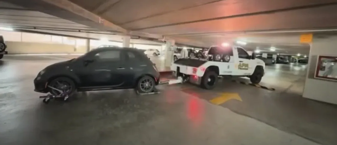 APM Towing performing a vehicle recovery inside a parking garage